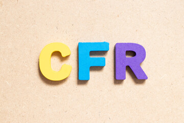 Sticker - Color alphabet letter in word CFR (abbreviation of Cost and freight) on wood background