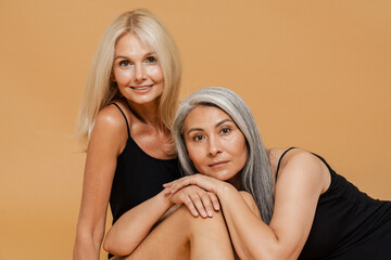 Wall Mural - Mature multiracial women wearing bodysuits smiling and posing