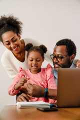 Wall Mural - African american man and woman with daughter making notes in notepad