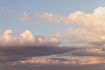Wall Mural - beautiful well balanced sky replacement sunset background with layers of fluffy white cumulus clouds