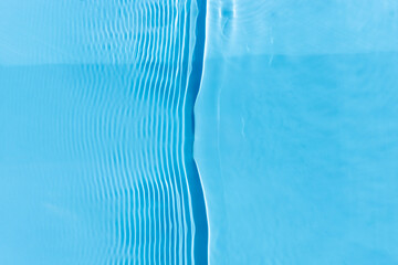 Wall Mural - Abstract background of blue water under sunlight. Top view, flat lay