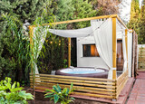 Fototapeta Londyn - Real estate photography of a brand new wooden exterior cabin with a inflatable hottub and sauna.
