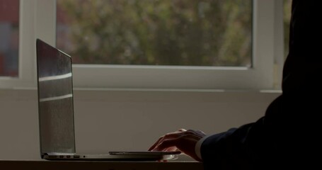 Poster - The beginning of the work day. The worker sits at the computer desk. He types text with his hands, adjusts the monitor. The use of technology in the transmission and accumulation of information.