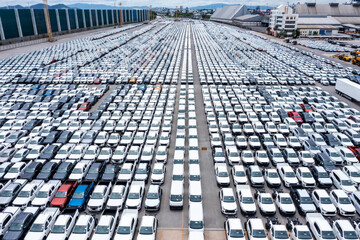 Wall Mural - Rows of a new cars parked in warehouse of  factory for distribution dealers trading in import export, aerial view