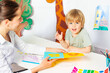 Early development class boy learns letters in kindergarten