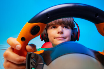 Wall Mural - Through the steering wheel of a gamer teen boy play race game