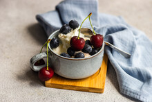 Close-up Of Vanilla Ice Cream With Fresh Blueberries And Cherries