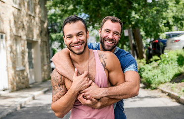 A Portrait of a happy gay couple outdoors in urban background