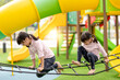 © FAMILY STOCK - Asian little girl enjoys playing in a children playground, Outdoor portrait