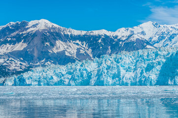 Wall Mural - A view of the end of the snout of the Hubbard Glacier with mountain backdrop in Alaska in summertime