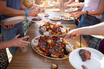 a lot of delicious food on plates on the table for people at a summer picnic