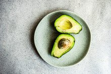 Overhead View Of A Halved Avocado On A Plate