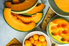 Overhead View Of Slices Of Cantaloupe Melon And Melon Balls Being Prepared On A Table