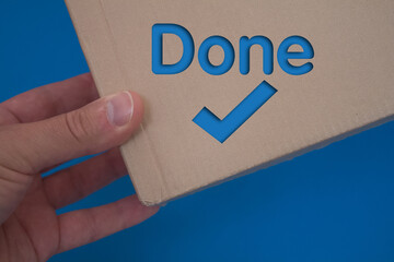 Poster - Done text with Checkmark with cardboard box. Brown folded cardbox.