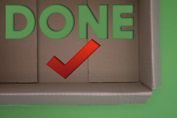Poster - Done text with Checkmark with cardboard box. Brown folded cardbox.