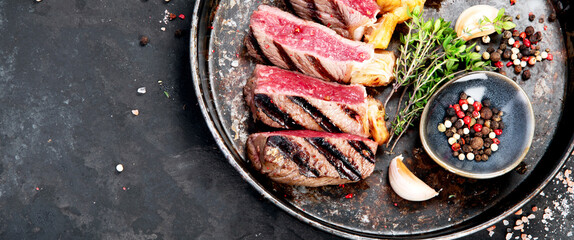 Wall Mural - Grilled beef steak with pepper and salt.