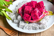 fresh white and pink red purple dragon fruit tropical in the asian thailand healthy fruit concept, dragon fruit slice on white plate with pitahaya background