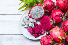 Fresh White And Pink Red Purple Dragon Fruit Tropical In The Asian Thailand Healthy Fruit Concept, Dragon Fruit Slice And Cut Half On White Plate With Pitahaya Background