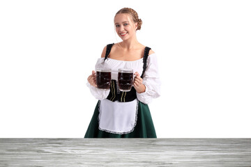 Wall Mural - Beautiful Oktoberfest waitress with mugs of beer near wooden table on white background