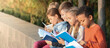 © Pixel-Shot - Cute little children reading books in park