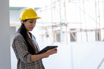 Aufkleber - Construction workers in helmets at building site working using tablet.