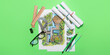 © Pixel-Shot - Paper sheets with sketches for landscape design and stationery on green background