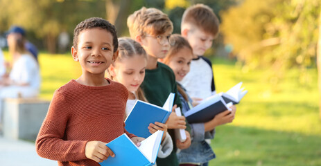 Canvas Print - Cute little children reading books in park