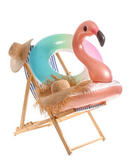 Deck chair with hats and inflatable rings on white background