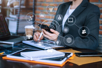 Women hand working with smart phone and laptop computer, tablet in modern office with virtual icon diagram at modern office.