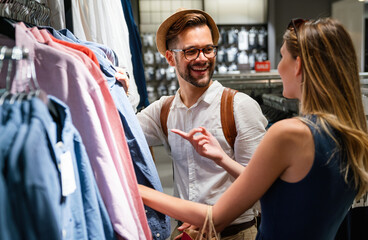 Wall Mural - happy young couple enjoying in shopping, having fun together. people love dating lifestyle concept
