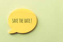 Bubble Speech Sticky Note With The Text Save The Date Over Textured Paper

