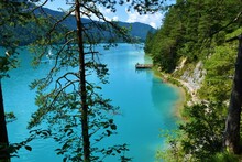 Walking Trail On The Shore Of Weissensee Lake In Turquoise Color In Carinthia, Austria