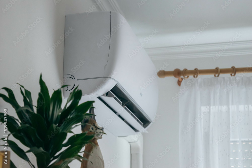 Split air conditioner on a white wall closeup Stock Photo | Adobe Stock