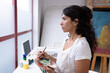 © Wavebreak Media - Image of biracial female artist working on new painting in studio