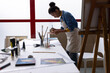 © Wavebreak Media - Image of biracial female artist working on new painting in studio