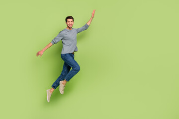 Poster - Full length photo of cheerful handsome male go on walk enjoy summer vacation isolated on green color background