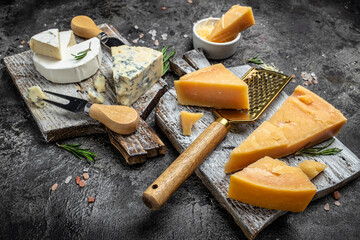 Wall Mural - set of hard and soft cheeses parmesan, dor blu chedar camamber brie. Different types of cheese on a wooden background. place for text, top view