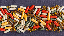 Heap Of Pills Close-up. Vitamin Dietary Supplements On On Burlap Rag. Immune Prevention Care Concept