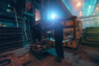 © DedMityay - Unrecognizable workers in steel mill load iron. Foundry factory, metallurgy industry.