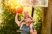 Happy Father And Child Daughter Outside At Basketball Court.