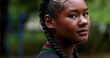 © Marco - Black girl staring to camera outside. Close-up African woman serious expression