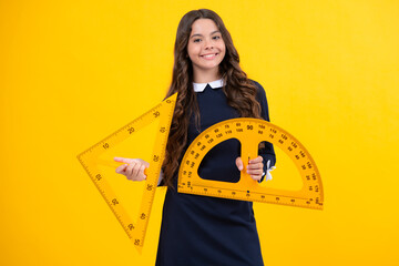 Poster - Schoolgirl in school uniform hold mathematics measure. Metric measurement. School equipment. Teenager student study stem disciplines.