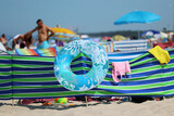 Fototapeta  - Parasol słoneczny na plaży nadmorskiej w wakacje razem z parawanem na wiatr. 