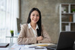 © amnaj - Confident and attractive Asian business woman Sit back and relax at work with your arms crossed, smiling and looking at the camera in the office.