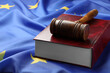 Leinwandbild Motiv Wooden judge's gavel and book on flag of European Union, space for text