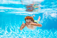 Underwater Child Swims In Pool, Healthy Child Swimming And Having Fun Under Water.