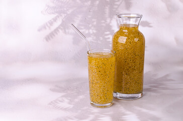 Wall Mural - Yellow drink with seeds in a glass