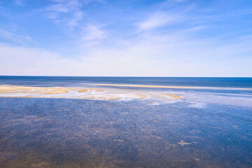 Beautiful, summer and blue beach with sand on sea water on a relaxing and calm sunny day in nature outside. Landscape view of the ocean and sky with copy space perfect for a getaway trip to relax