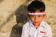 Portrait of Indonesian elementary school student wearing red white attribute to celebrate independence day.
