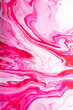 Abstract background of mixed shades of nail polish with a marble pattern. Liquid colorful paint background creative watercolor: pink, cream